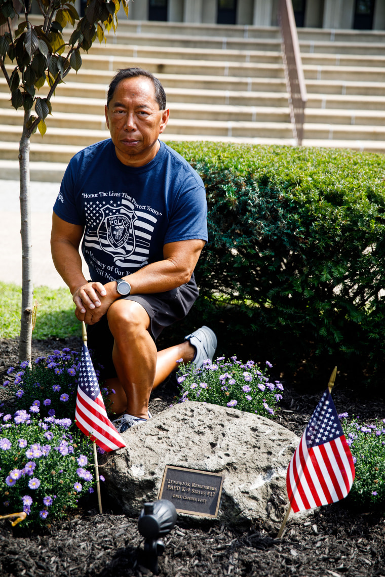 Lim kneels next to Sirius' plaque during a visit to the memorial on Sept. 4, 2021.