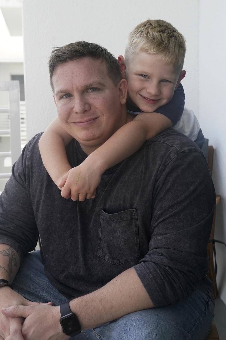 Associated Press investigative reporter James LaPorta and his son Joel, 5, sit at their home, Tuesday, Sept. 7, 2021, in Boca Raton, Fla.  LaPorta  recalls a boy he encountered in Afghanistan back in  2013 while serving as a Marine. (AP Photo/Marta Lavandier)
