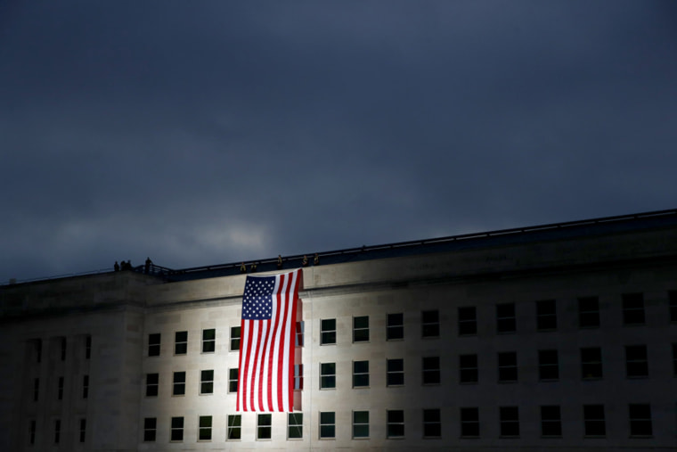 An American flag is unfurled at sunrise at the Pentagon on Sept, 11, 2020 to honor the 184 people killed in the 2001 terrorist attack.