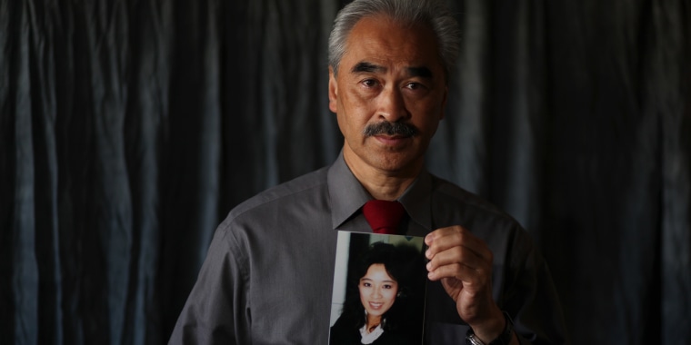 Betty Ong's brother Harry holds a portrait of her at his home in San Francisco on Sept. 6, 2011.