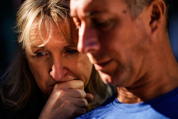 A couple gathers with others outside the National September 11 Memorial and Museum.