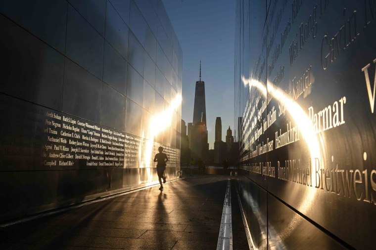 A woman runs at sunrise at the Empty Sky 9/11 Memorial in Liberty State Park in Jersey City, New Jersey.
