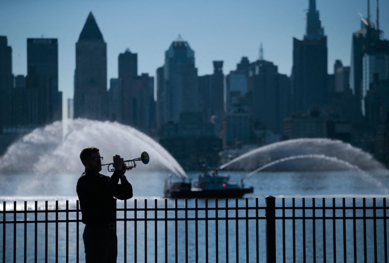 A man plays a trumpet during the ceremony in New York City.