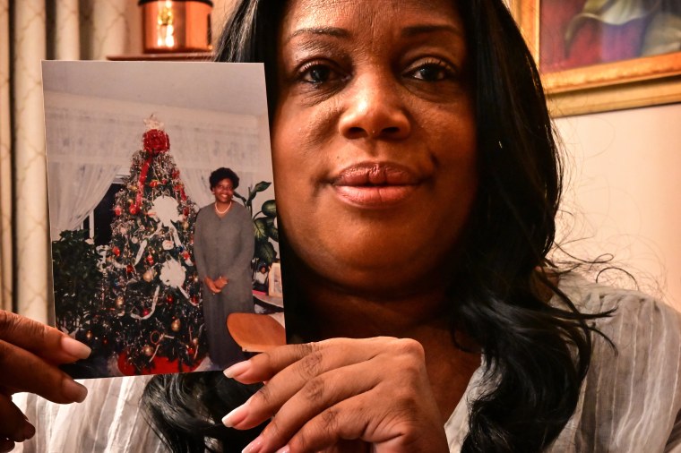 Woman holds photo of mother who died on 9/11 and whose remains have recently been identified