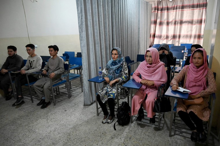 Image: Students attend a class divided by a curtain separating males and females at a private university in Kabul on September on Tuesday.