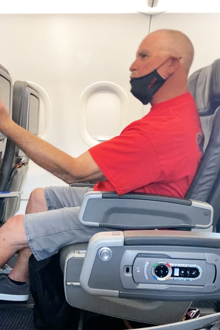 An angry passenger makes an obscene gesture toward a flight attendant on an American Airlines flight from Los Angeles on Sept. 6, 2021.