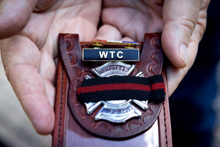 Kevin Maxwell shows the pins he received for his service and his badge.