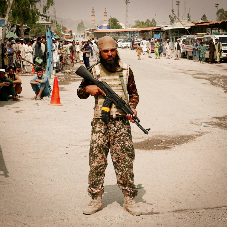 Taliban militants stand guard on the Afghanistan side of the Torkham border crossing with Pakistan.