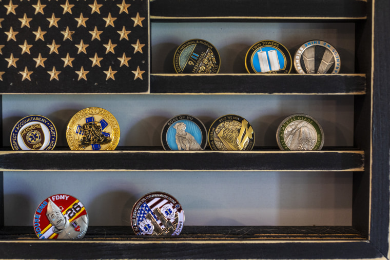 Image: A collection of 9/11 memorial challenge coins hang on a wall of the home of Jennifer Waddleton on Sept. 9, 2021 in Lehigh Acres, Fla.