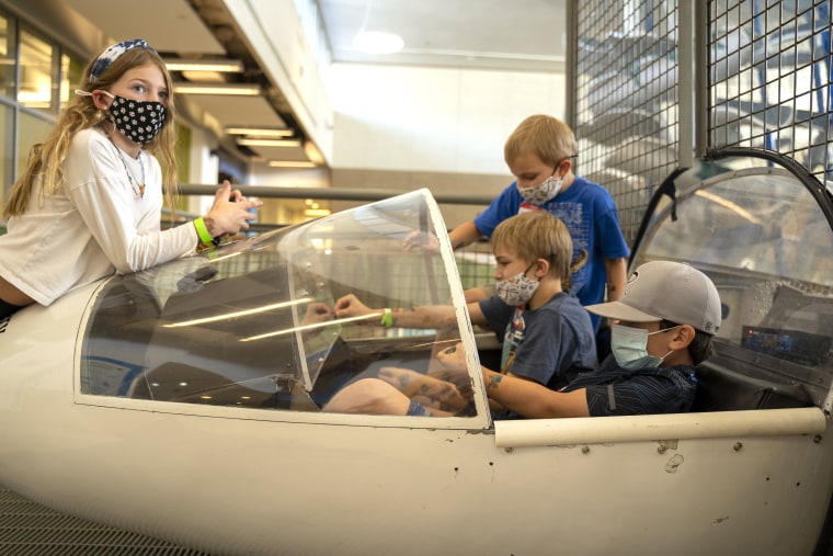 Children displaced by the Caldor Fire play in a glider at The Discovery Museum.