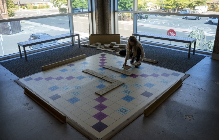A child plays with a giant Scrabble board at The Discovery Museum. 