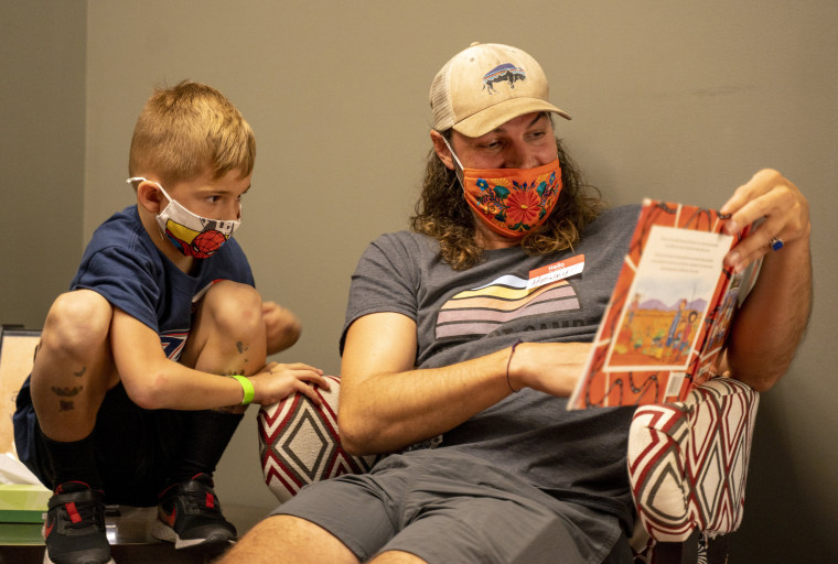 Henry Meier with Project:Camp reads a book to campers at The Discovery Museum.