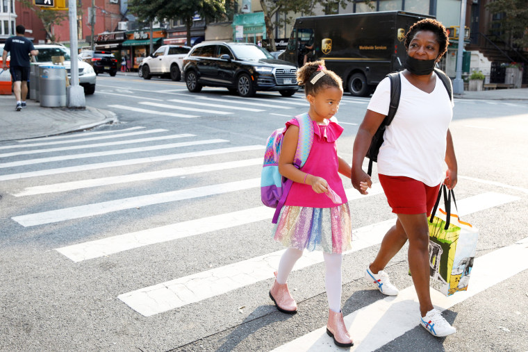 A student walks to school on the first day of school in Brooklyn, N.Y., on Sept. 13, 2021.