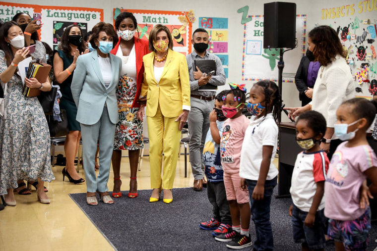 Rep. Maxine Waters, D-Calif., left, Ifetayo Ewing, director of Ethel Bradley Early Education Center, and House Speaker Nancy Pelosi are greeted by students before a news conference to discuss the importance of the Child Tax Credit at the Ethel Bradley Ear