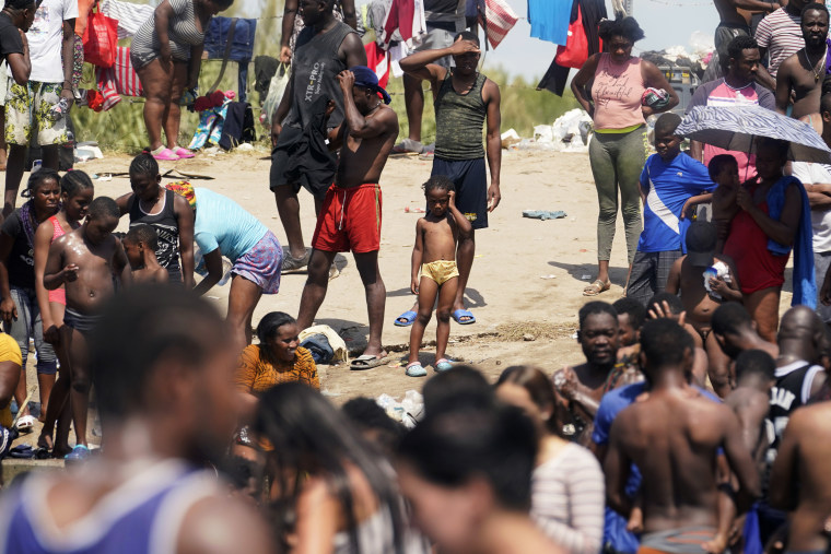 Haitian migrants gather on the banks of the Rio Grande after they crossed into the United States from Mexico on Sept. 18, 2021, in Del Rio, Texas.