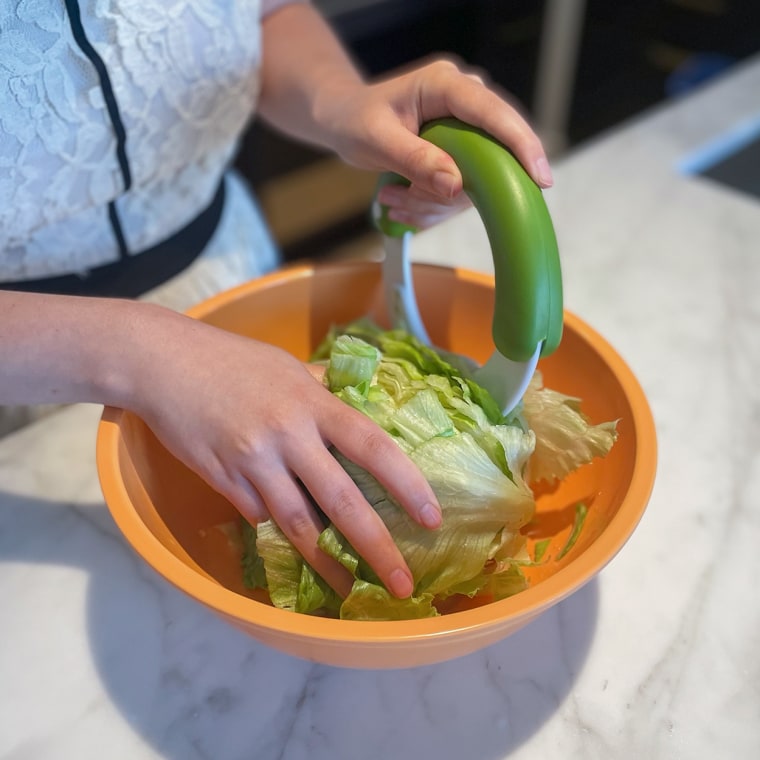 Writer Abigail Barr using a salad chopper famous on TikTok to chop up romaine lettuce