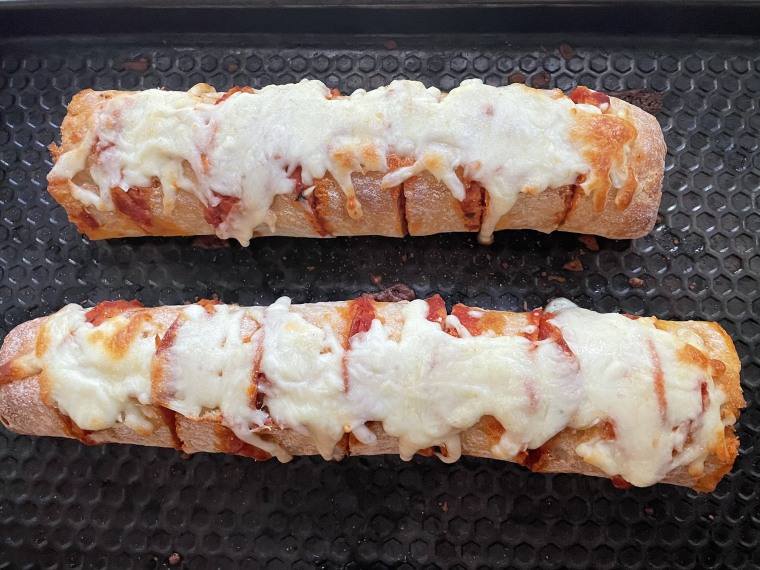 This pizza baguette is crunchy on the outside, soft and fluffy on the inside and oozing with cheese.