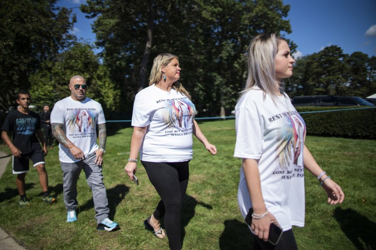 People wear T-shirts with images of Petito as they attend the funeral service of Gabby Petito at Moloney's Funeral Home in Holbrook, N.Y. Sunday, Sept. 26, 2021.