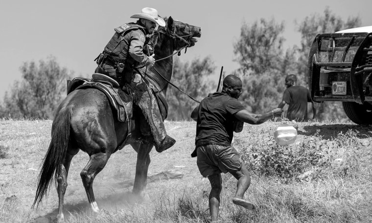 A United States Border Patrol agent on horseback tries to stop a Haitian migrant from entering an encampment on the banks of the Rio Grande near the Acuna Del Rio International Bridge in Del Rio, Texas on Sep. 19, 2021.