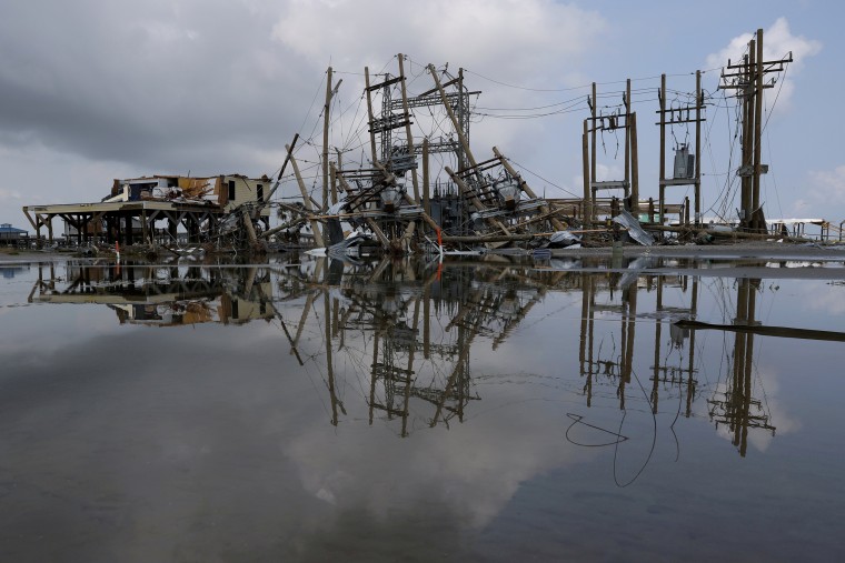 Image: Damaged power lines and homes in Grand Isle, La.