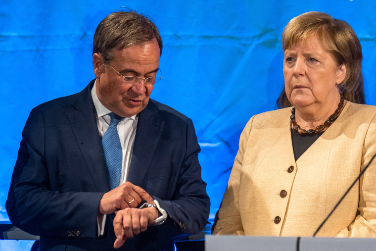 Angela Merkel stands next to Armin Laschet.