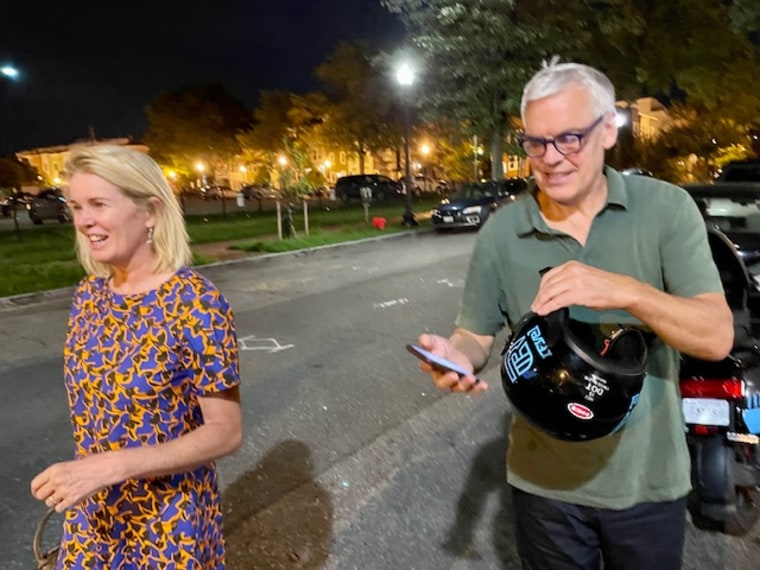 Katty Kay and her husband getting off a Vespa. After their daughter left for boarding school, a friend told Kay to try something fun, so she signed up for a Vespa sharing app.