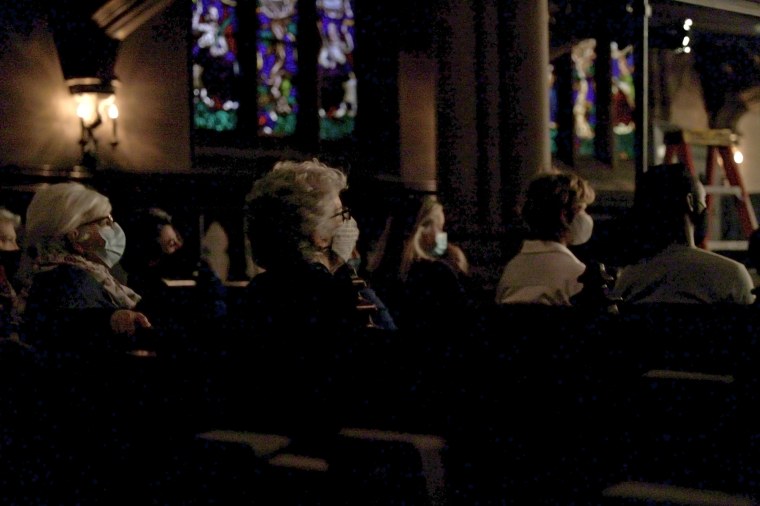 Image: Masked attendees watch The Moth true personal storytelling show live-streamed from St. Ann's Church on April 21, 2021 in Brooklyn, N.Y.