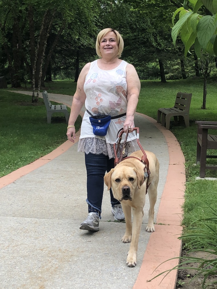 Joanne Callahan walks with her current guide dog, Magnum