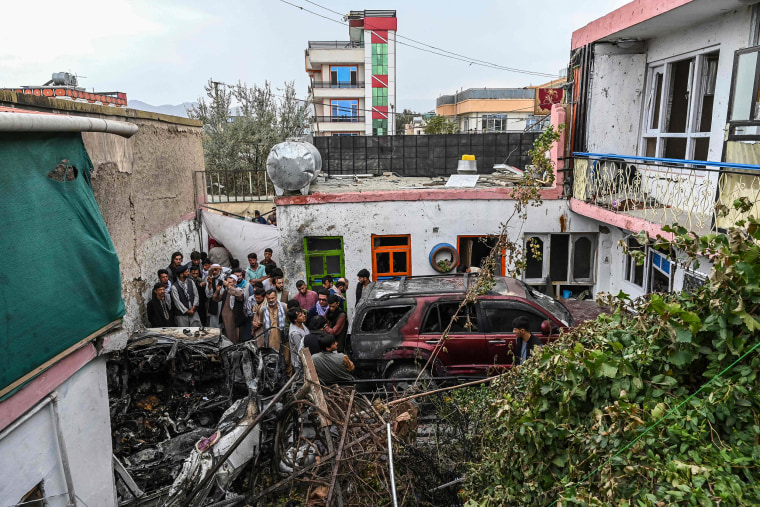 Image: Residents and family members gather next to a damaged vehicle inside a day after a U.S. drone airstrike in Kabul on Sunday.