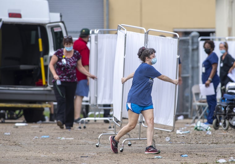 Image: Panels are carried in front of a mass shelter as paramedics evacuate nursing home residents on Sept. 2, 2021 in Independence, La., where they had been taken ahead of hurricane Ida.