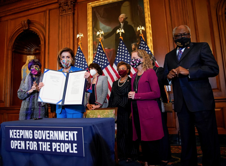 Image: U.S. House Speaker Nancy Pelosi signs continuing resolution during bill enrollment ceremony on Capitol Hill in Washington