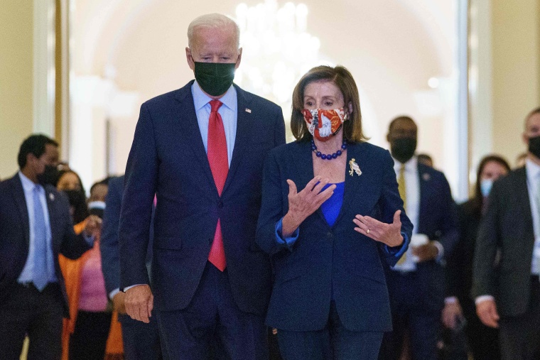 Image: President Joe Biden walks with Speaker of the House Nancy Pelosi as he departs the Capitol after a caucus meeting in Washington on Oct. 1, 2021.