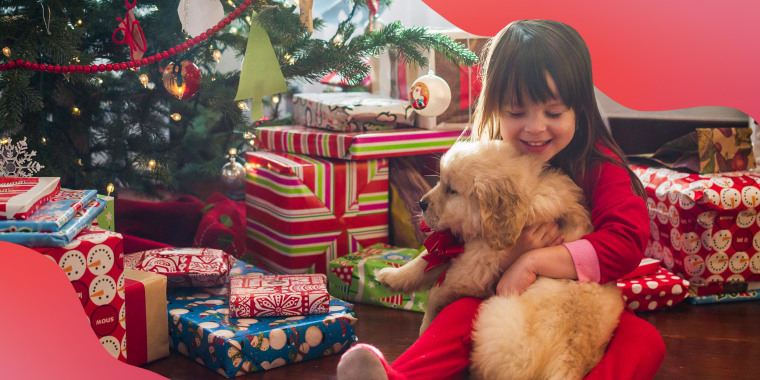 Little girl hugging a puppy she got for Christmas