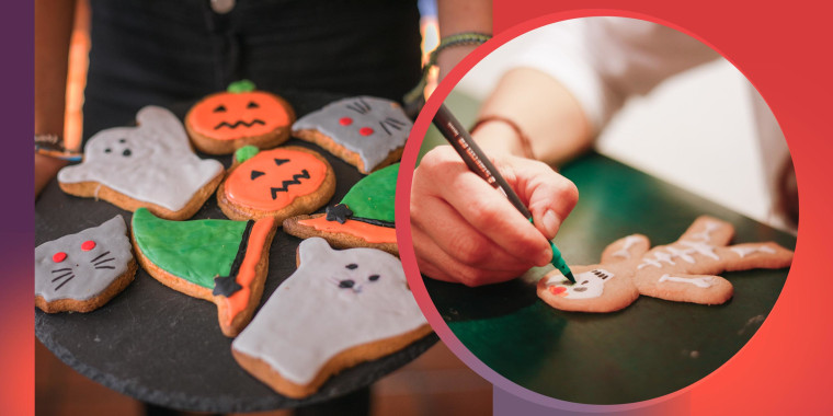 Someone holding a platter of halloween handmade cookies and a kid making skeleton