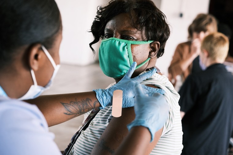 Image: A woman receives a Covid-19 vaccine on Aug. 4, 2021 in Ferguson, Mo.