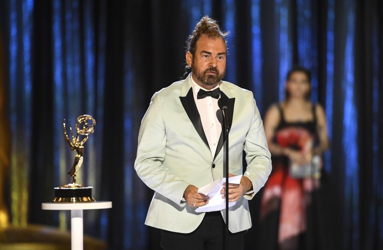 Marc Pilcher accepts the award for outstanding period and/or character hairstyling for the \"Art of the Swoon\" episode of \"Bridgerton\" during night one of the Television Academy's 2021 Creative Arts Emmy Awards on Sept. 11, 2021, in Los Angeles.