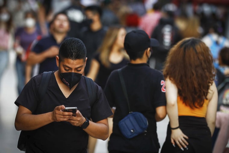 A man checks his phone in Mexico City on Oct. 4, 2021.