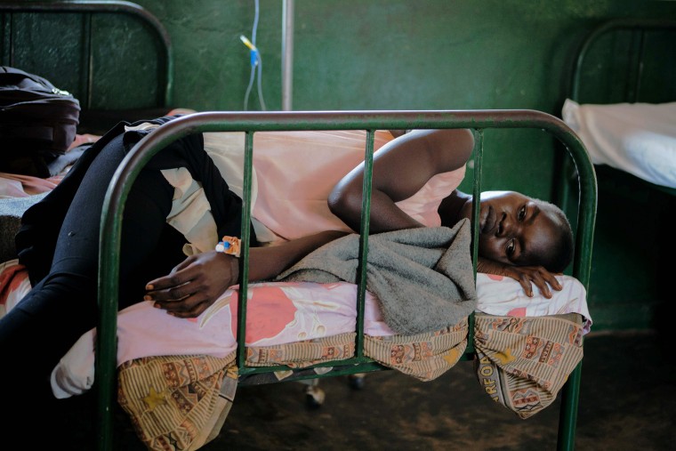 A patient rests on a bed after being discharged from the malaria ward at Panyadoli Health Center III in Kiryandongo refugee settlement, northwestern Uganda, on April 11, 2017.