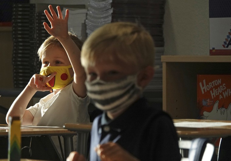 Image: First Graders Alex Albin, left, and Tyler Custodio wear masks in at Addison Mizner School in Boca Raton, Fla., on Aug. 10, 2021.