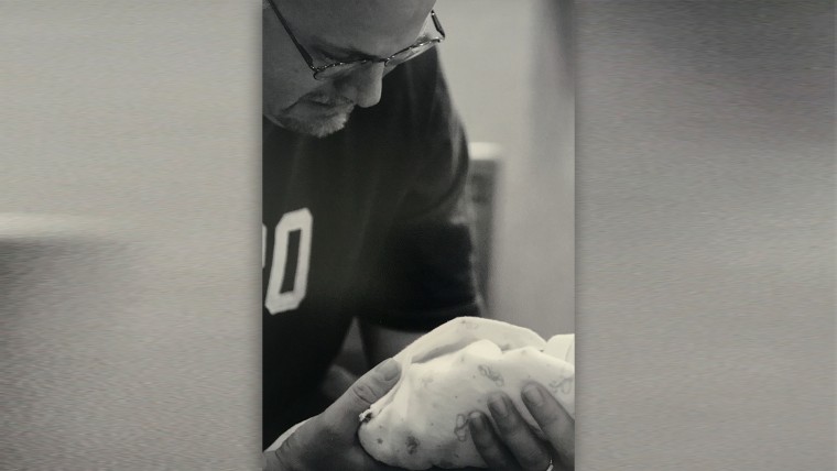 Author Kelly Farley holds his son Noah, who was born prematurely and stillborn.