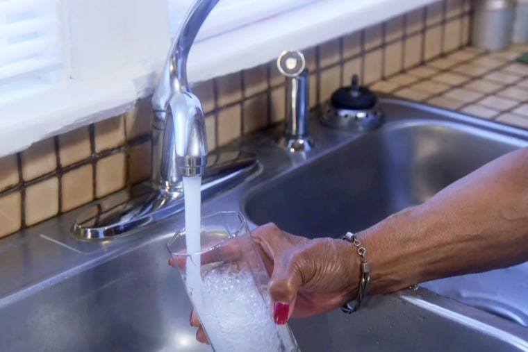 Image: A resident fills a cup with tap water, in Benton Harbor, Mich.