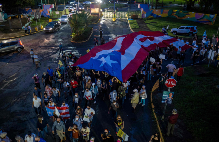 Image: Protesters march along Las Americas Highway to demand the expulsion of power company Luma amid a continued lack of electricity across the island, in San Juan, Puerto Rico on Oct. 15, 2021.