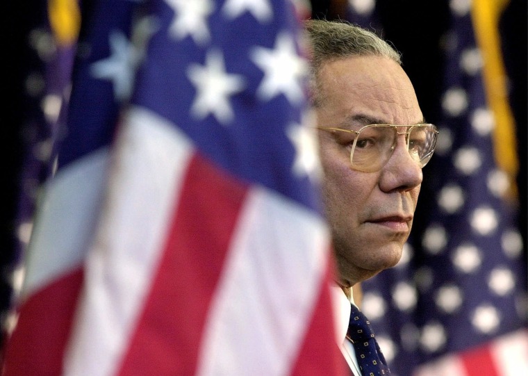 Secretary of State Colin Powell looks on as President Bush addresses State Department employees on Feb. 15, 2001.