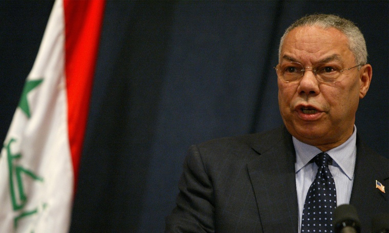 Image: Colin Powell speaking at a press conference in Baghdad.