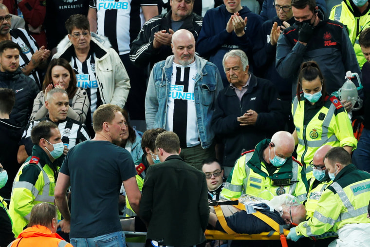 A Newcastle fan is stretchered away from the stands by paramedics at St. James' Park in Newcastle, Britain, on Oct. 17, 2021.