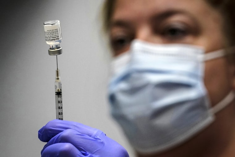 A pharmacy technician loads a syringe with Pfizer's Covid-19 vaccine at the Portland Expo in Portland, Maine on March 2, 2021.