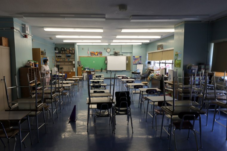 Image: A principal surveys a classroom in preparation for the start of school on Sept. 2, 2021.