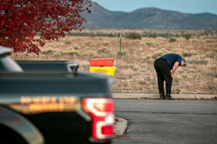 Alec Baldwin leans over in the parking lot outside the Santa Fe County Sheriff's offices after being questioned on the shooting.