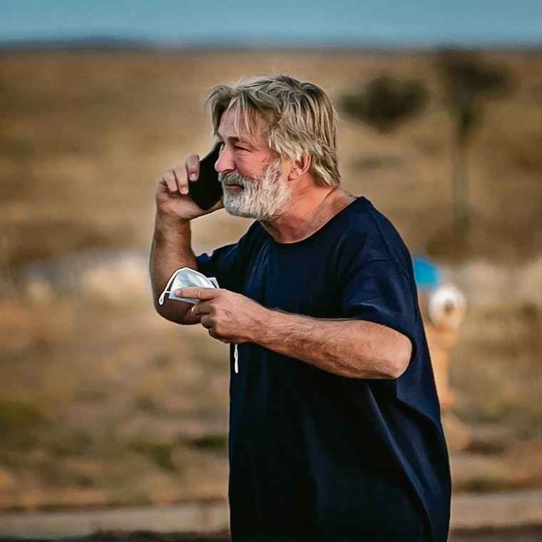 Image: Alec Baldwin takes a call in the parking lot outside the sheriff's offices.