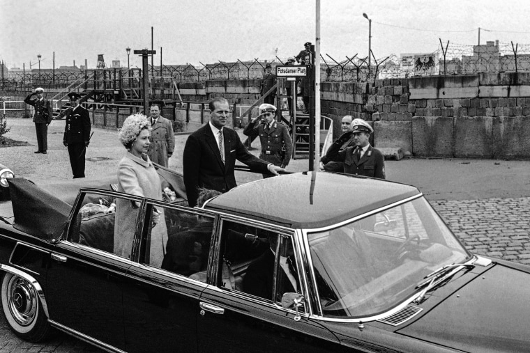 Queen Elizabeth II and Prince Philip driving in the Potsdamer Platz where they had a close view of the wall dividing East and West Germany, during a sightseeing tour of West Berlin on the last stages of their state visit to West Germany, on May 27, 1965.